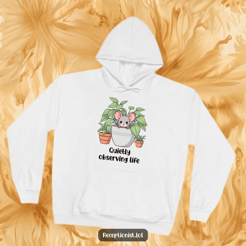 Funny, cozy hoodie depicting a shy mouse concealed behind a large potted plant, offering warmth and subtle humor.